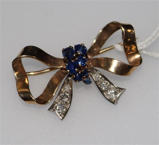 A gold, sapphire and diamond set bow brooch. 34mm.